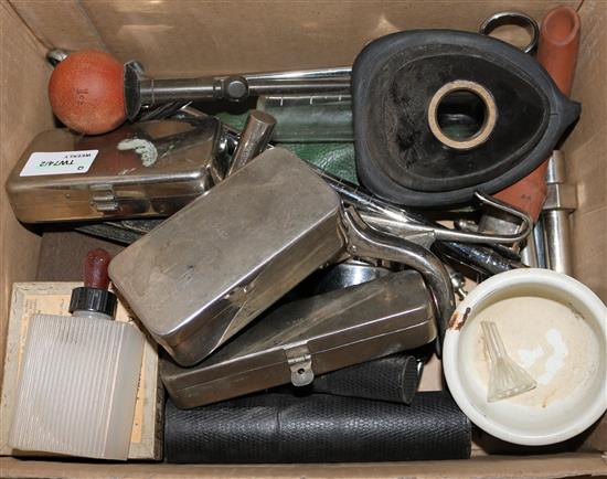 A collection of medical equipment, including, torch, syringes, etc, some items in metal cases
